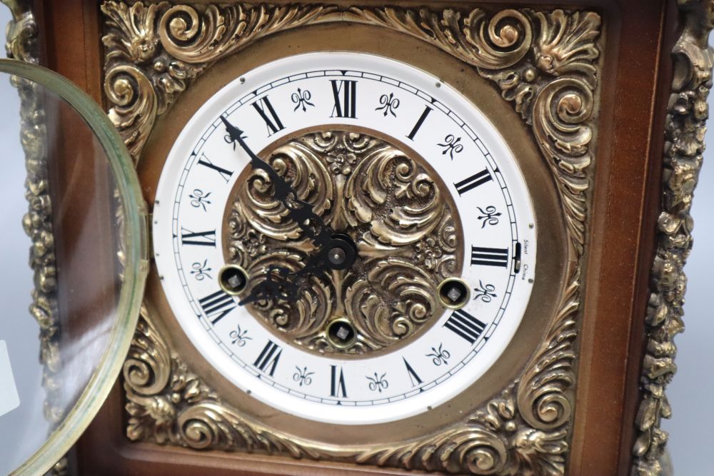 A German ornately carved and brass mounted mantel clock, height 34cm